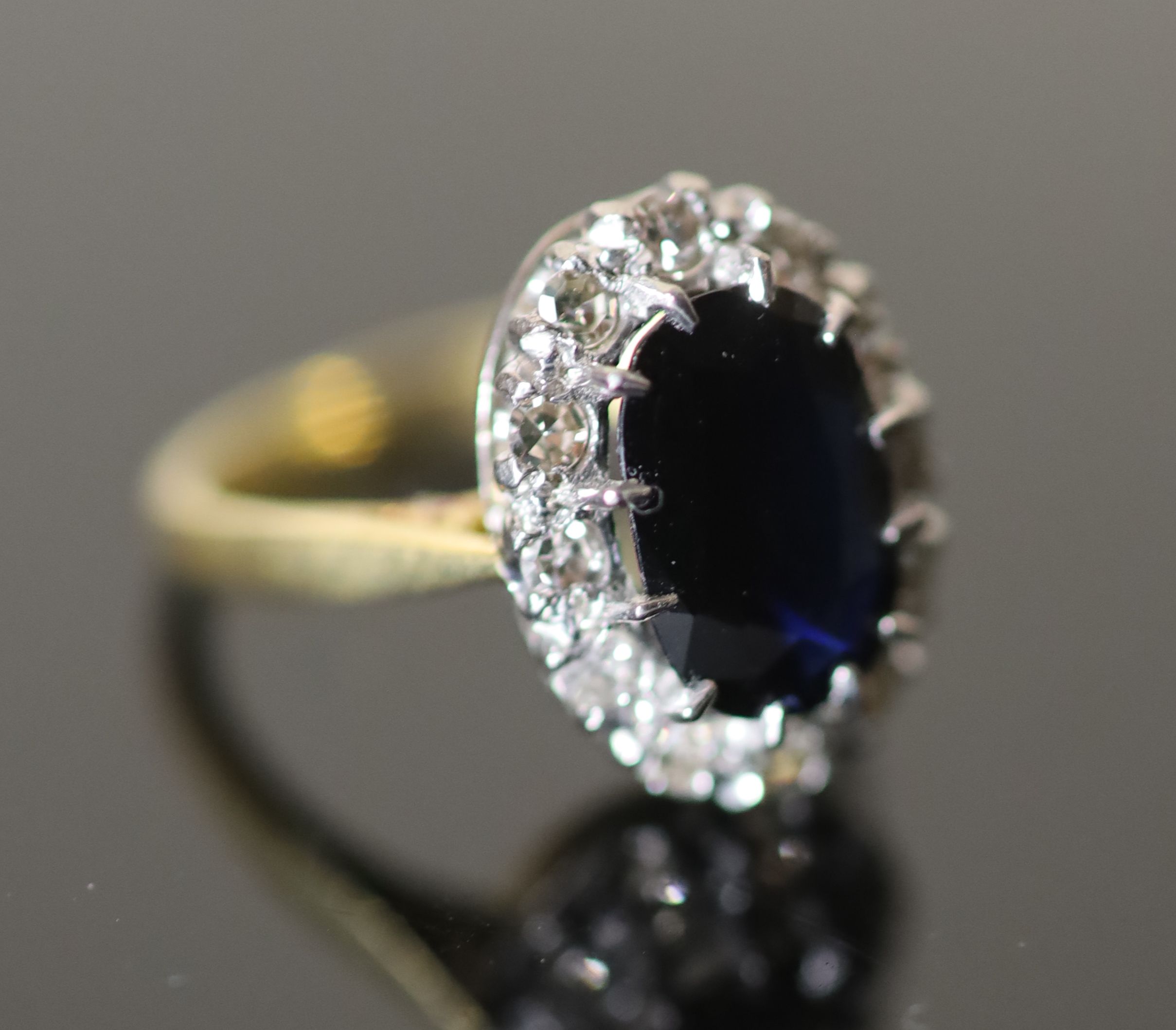 A 20th century 18ct gold, sapphire and diamond set oval cluster ring,
